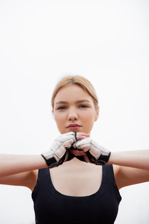 low angle view of young woman warming up in fitness gloves outdoorsの写真素材