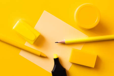 top view of stationery and paper note on yellowの写真素材