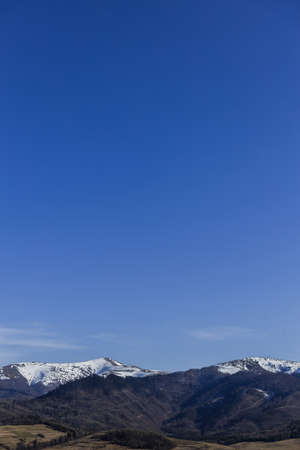 Landscape with mountains with snow and blue sky at backgroundの写真素材