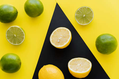 Top view of ripe limes yellow and lemons on black background
