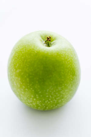 delicious whole green apple on whiteの写真素材
