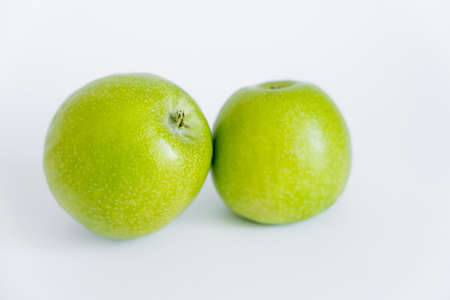 green and ripe apples on whiteの写真素材