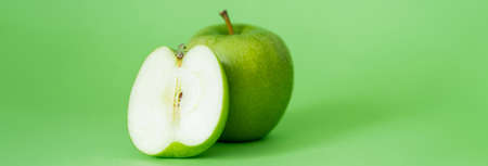 organic and fresh apples on green background, bannerの写真素材