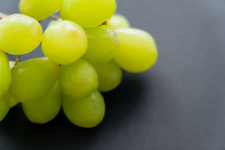 close up view of fresh grapes on blackの写真素材