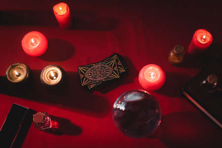 KYIV, UKRAINE - FEBRUARY 23, 2022: top view of tarot cards near candles and witchcraft supplies on tableのeditorial素材