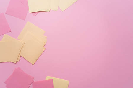 top view of empty pastel paper notes on pink