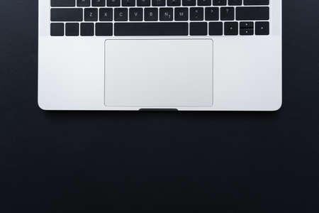 top view of laptop keyboard and touchpad on black