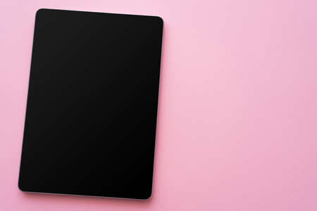 top view of digital tablet with blank screen on pinkの写真素材