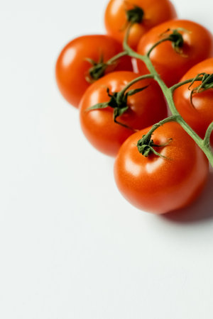 Close up view of fresh cherry tomatoes on white backgroundの写真素材