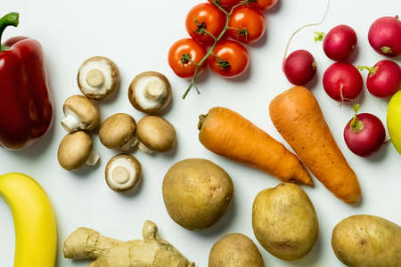 Top view of organic fruits and vegetables on white background