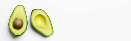 Top view of fresh cut avocado on white background with copy space, banner