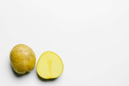 Top view of cut and whole potatoes on white backgroundの写真素材