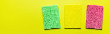 top view of bright absorbent sponge rugs on yellow background, bannerの写真素材