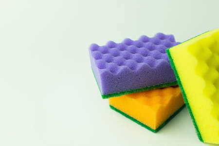 purple, orange and yellow sponges on grey backgroundの写真素材