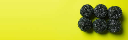top view of stainless scourers on yellow background with copy space, bannerの写真素材