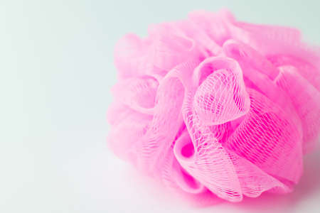 close up view of pink mesh washcloth on grey backgroundの写真素材