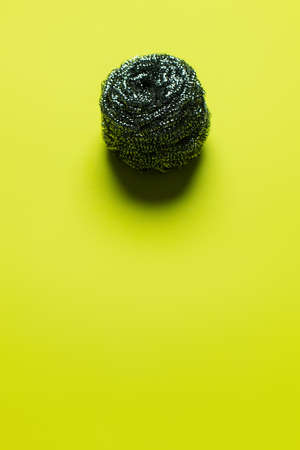 top view of cleansing wire scrubber on yellow background with copy spaceの写真素材