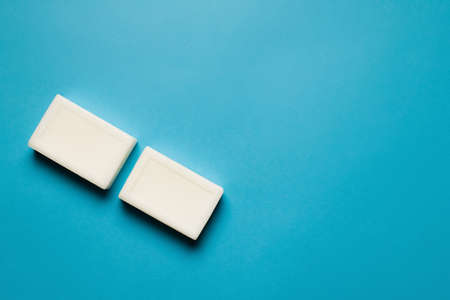 top view of two toilet soap bars on blue background with copy spaceの写真素材