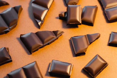 Top view of natural dark chocolate on brown backgroundの写真素材