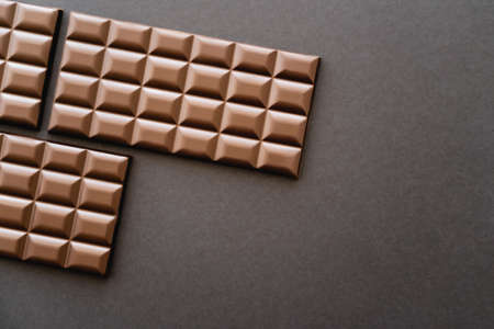 Top view of chocolate bars on black surfaceの写真素材
