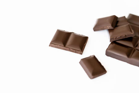 Close up view of blurred chocolate pieces isolated on whiteの写真素材