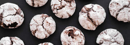Top view of tasty biscuits with powdered sugar on black background, bannerの写真素材