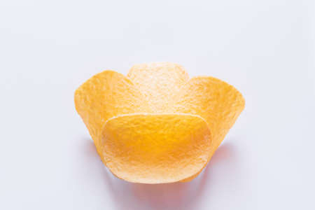 close up of salty potato chips on white background