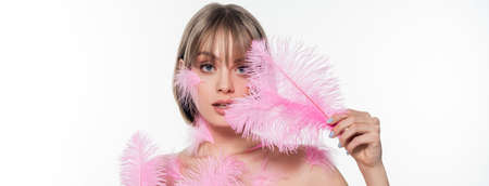 pretty woman with decorative beads on neck holding pink feathers isolated on white, banner