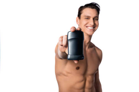 happy shirtless man showing dry deodorant on blurred background isolated on whiteの写真素材