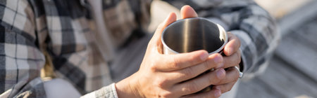 Cropped view of man holding cup outdoors, bannerの写真素材