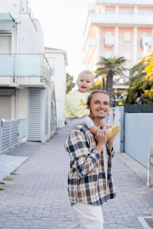 Man holding smiling baby girl on urban street in Trevisoの写真素材