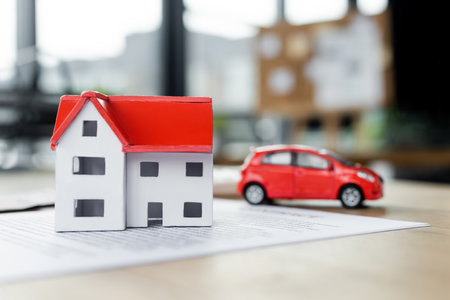 carton house model and toy car on document, tax conceptの写真素材