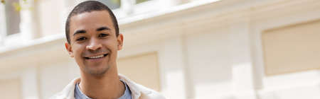 young and happy african american man smiling in urban city, bannerの写真素材