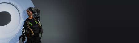 Sequence shot of stylish african american woman posing near abstraction on grey background, banner