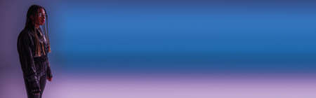 Trendy african american woman in smart glasses on blue and purple background, banner
