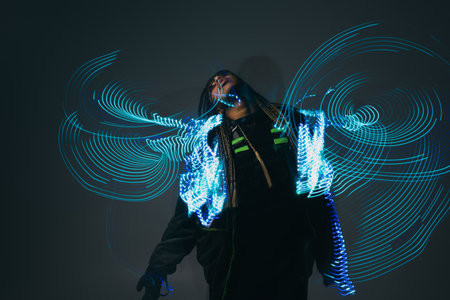 African american woman in smart glasses posing near abstract projection on grey backgroundの写真素材