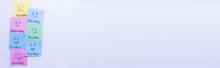 top view of multicolored cards with different emoji and day names on pastel violet background, bannerの写真素材