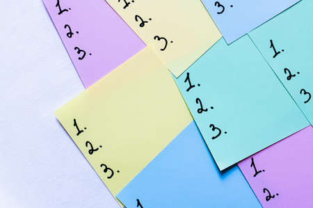 top view of multicolored sticky notes with numbers on white background