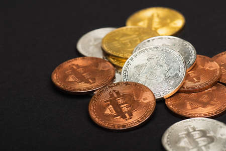 KYIV, UKRAINE - APRIL 26, 2022: Close up view of crypto coins on black backgroundのeditorial素材