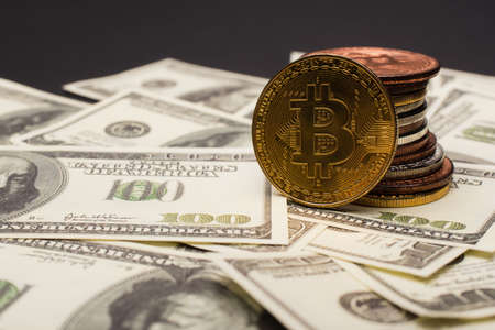 KYIV, UKRAINE - APRIL 26, 2022: Close up view of crypto coins on dollars isolated on black