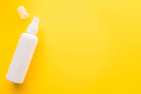 Top view of sunblock with cap on yellow surfaceの写真素材