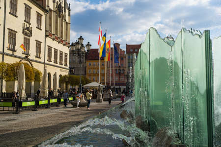 WROCLAW, POLAND - APRIL 18, 2022: Fountain on urban street at daytime