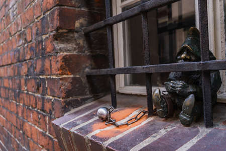 WROCLAW, POLAND - APRIL 18, 2022: Gnome statue on windowsill on streetのeditorial素材