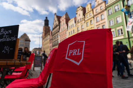 WROCLAW, POLAND - APRIL 18, 2022: Chairs and tables on outdoor cafe on urban streetのeditorial素材