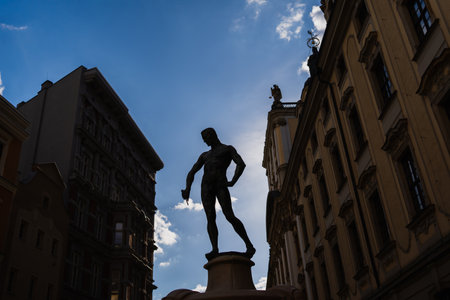 WROCLAW, POLAND - APRIL 18, 2022: Silhouette on Fencer Fountain with sky at backgroundのeditorial素材