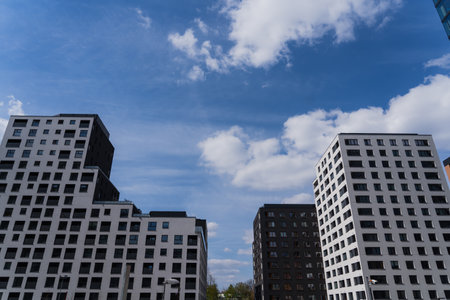 Low angle view of modern buildings with blue sky at background in Wroclawの写真素材