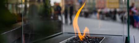 Close up view of fire in transparent box on street in Wroclaw, bannerの写真素材