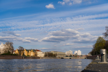 Buildings near river and sky at background in Wroclawの写真素材