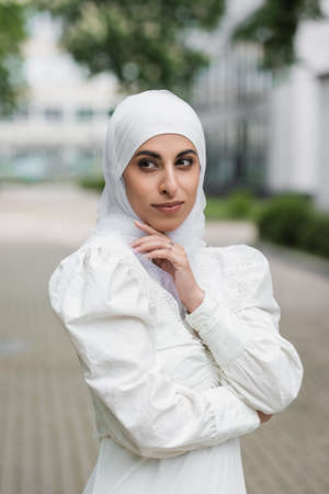 portrait of muslim bride in hijab with diamond ring on finger looking awayの写真素材
