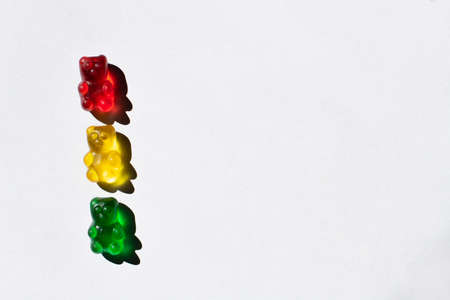 Top view of colorful gummy bears on white background with copy spaceの写真素材